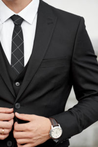 Man in custom tailored business suit posing